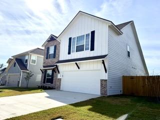 view of front facade featuring a garage and a front lawn