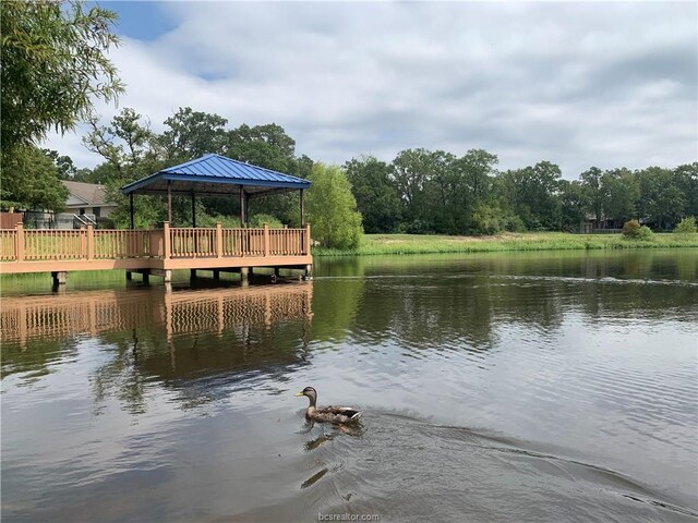 view of dock with a gazebo and a water view