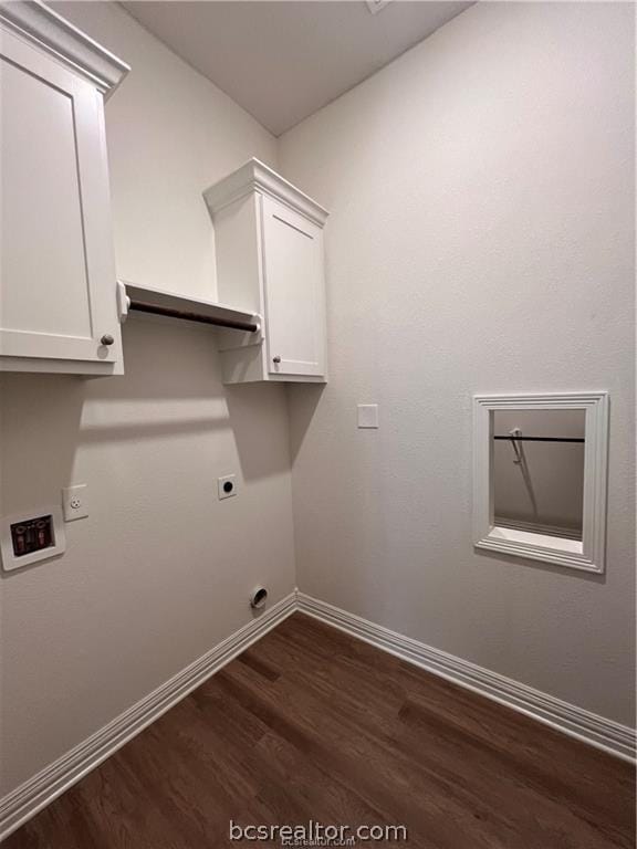 clothes washing area featuring hookup for an electric dryer, dark hardwood / wood-style flooring, and cabinets