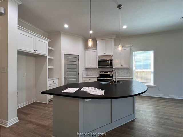 kitchen featuring a center island with sink, white cabinets, sink, and appliances with stainless steel finishes