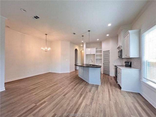 kitchen featuring pendant lighting, crown molding, white cabinetry, and stainless steel range with electric cooktop