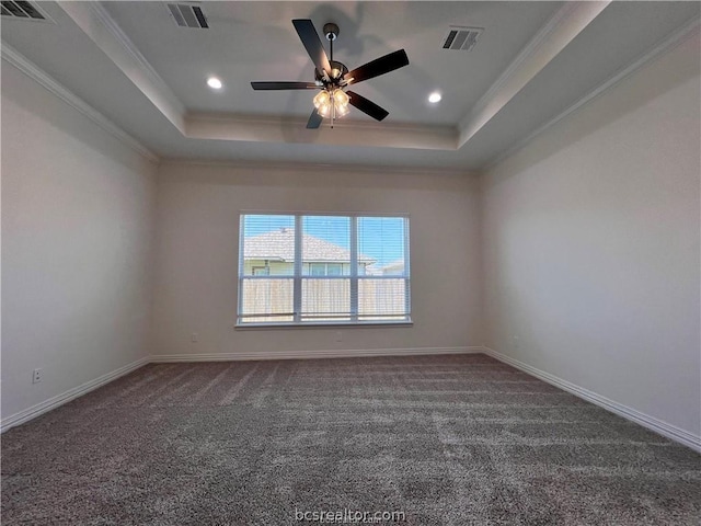 carpeted empty room with ceiling fan, ornamental molding, and a tray ceiling