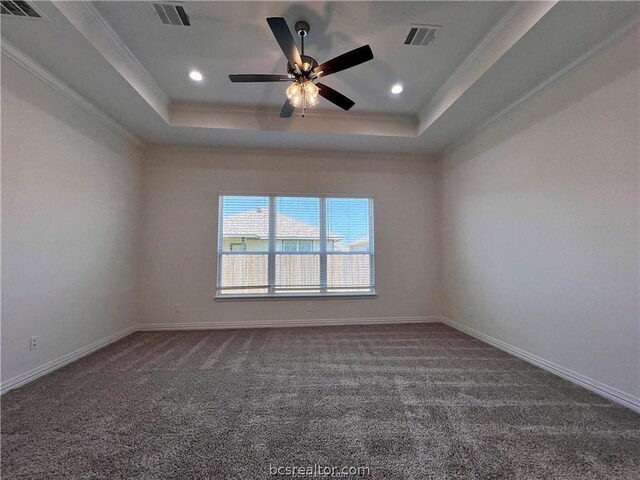 carpeted empty room with ceiling fan, ornamental molding, and a tray ceiling