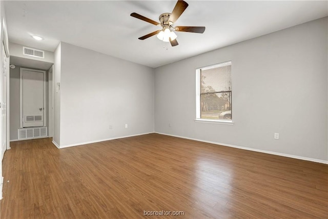 spare room with hardwood / wood-style flooring and ceiling fan