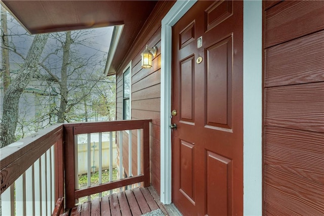 view of exterior entry featuring a balcony