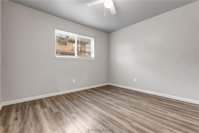 unfurnished room with hardwood / wood-style floors and ceiling fan