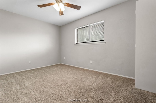 carpeted spare room with ceiling fan