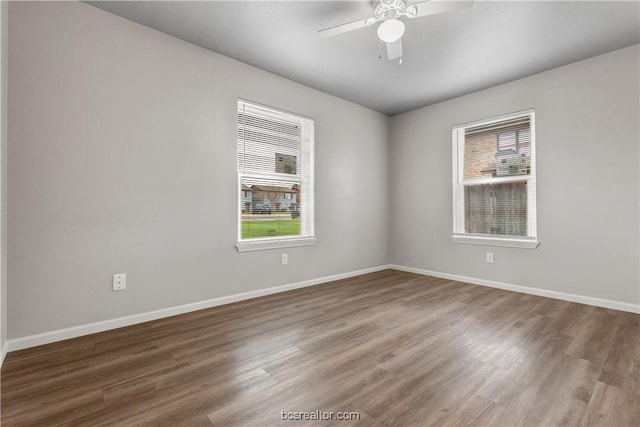 spare room with hardwood / wood-style floors and ceiling fan