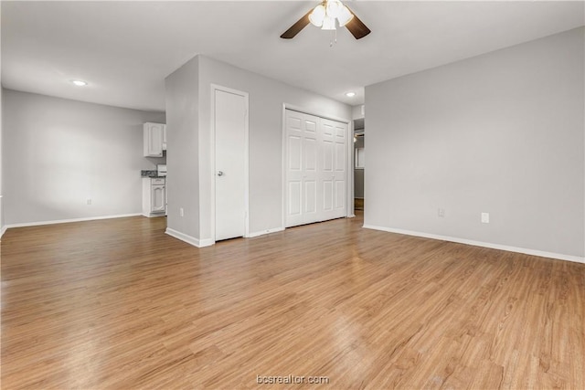 unfurnished living room with ceiling fan and light hardwood / wood-style floors