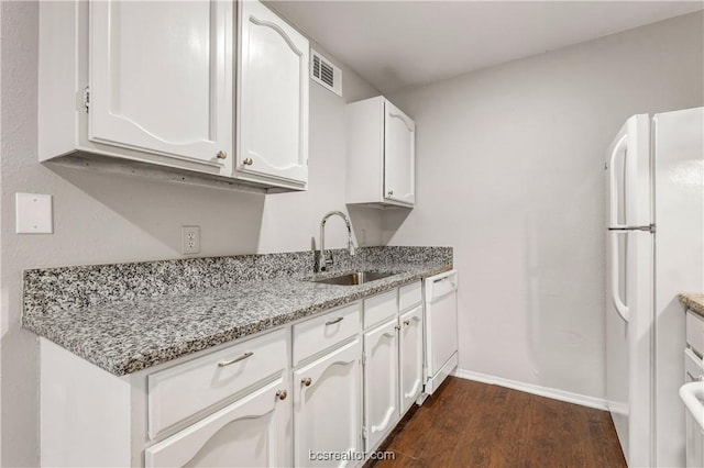 kitchen featuring white cabinetry, sink, light stone counters, and white appliances