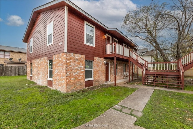 view of home's exterior featuring a wooden deck and a yard