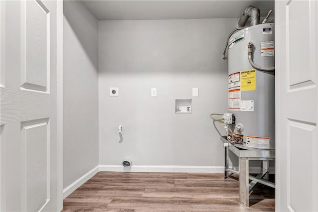 washroom with hookup for an electric dryer, hookup for a washing machine, hardwood / wood-style floors, and gas water heater