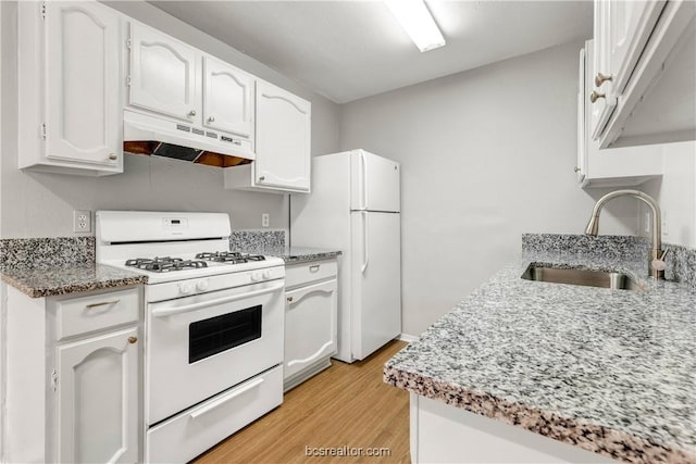 kitchen with sink, white cabinetry, light wood-type flooring, white appliances, and light stone countertops