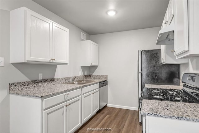 kitchen with white cabinetry, appliances with stainless steel finishes, sink, and light stone counters