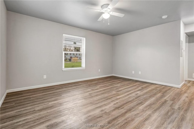 spare room featuring wood-type flooring and ceiling fan