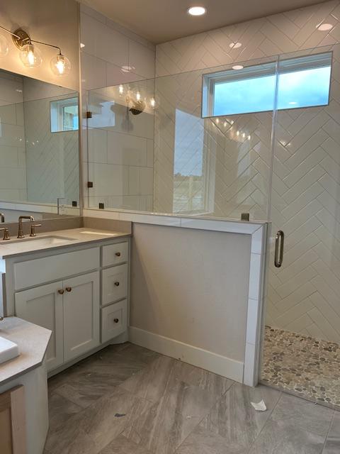 bathroom with vanity and a shower with shower door