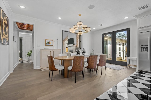 315 Suffolk Ave, College Station, TX 77840 - dining area with visible vents, light wood finished floors, ornamental molding, french doors, and a notable chandelier