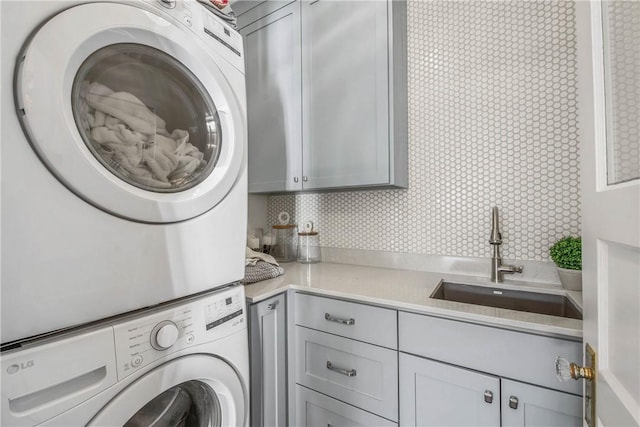 315 Suffolk Ave, College Station, TX 77840 - laundry area with cabinet space, stacked washer / drying machine, and a sink
