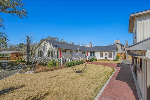 315 Suffolk Ave, College Station, TX 77840 - rear view of property featuring a lawn