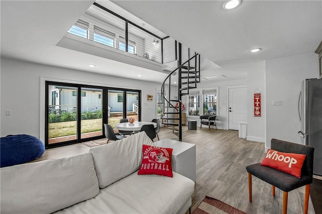 315 Suffolk Ave, College Station, TX 77840 - living room featuring recessed lighting, stairway, a healthy amount of sunlight, and wood finished floors