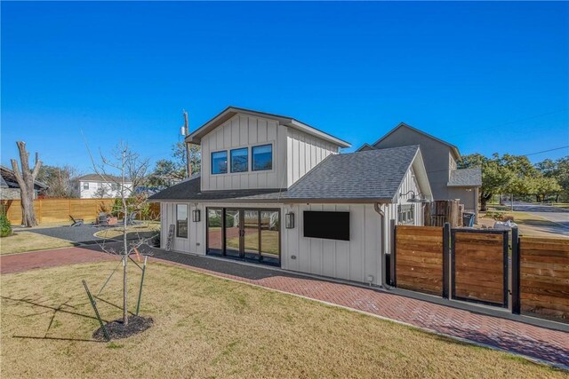 315 Suffolk Ave, College Station, TX 77840 - back of property with a lawn, board and batten siding, a shingled roof, and fence