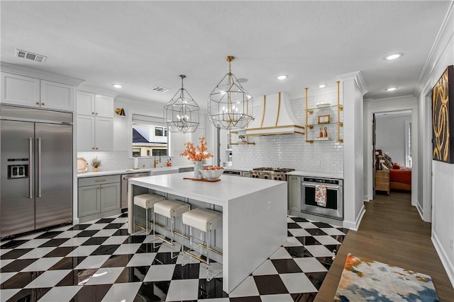 315 Suffolk Ave, College Station, TX 77840 - kitchen with light countertops, premium range hood, appliances with stainless steel finishes, and ornamental molding