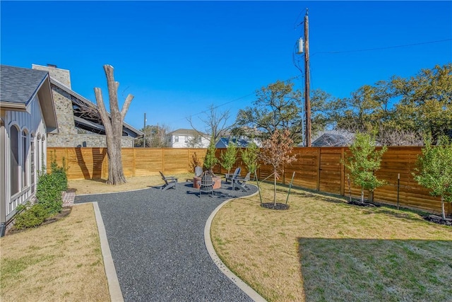 315 Suffolk Ave, College Station, TX 77840 - view of yard featuring a patio area, a fenced backyard, and an outdoor fire pit