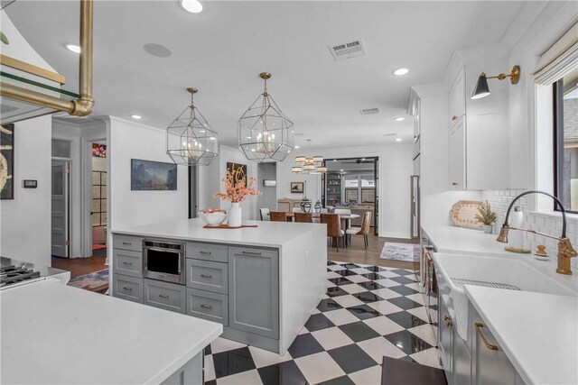 315 Suffolk Ave, College Station, TX 77840 - kitchen with tile patterned floors, visible vents, recessed lighting, crown molding, and light countertops