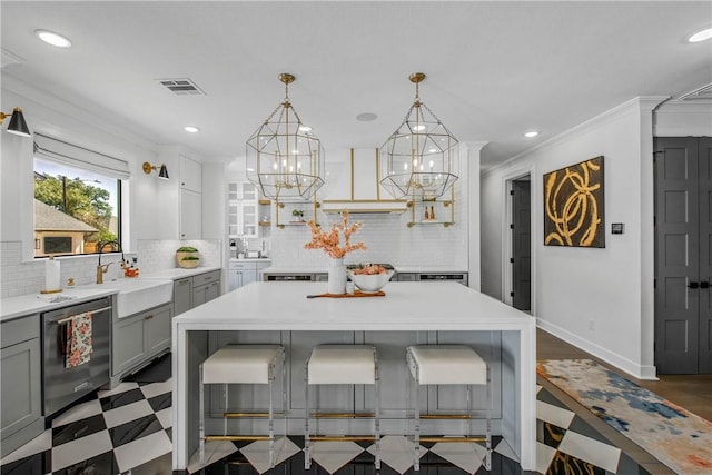 315 Suffolk Ave, College Station, TX 77840 - kitchen featuring custom exhaust hood, dishwasher, a breakfast bar, and gray cabinetry