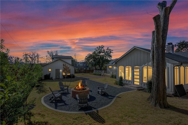 315 Suffolk Ave, College Station, TX 77840 - rear view of house featuring a lawn, board and batten siding, a fire pit, and a patio