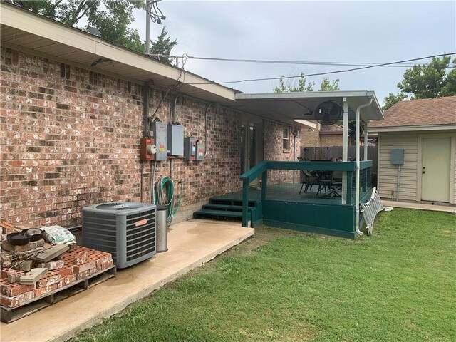 1707 Shawnee St, Navasota, TX 77868 - back of property featuring a lawn, brick siding, and a deck