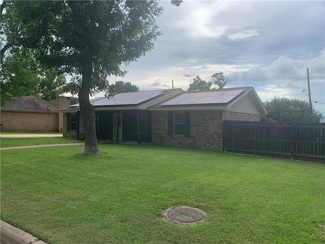 1707 Shawnee St, Navasota, TX 77868 - ranch-style home featuring roof mounted solar panels, brick siding, and a chimney