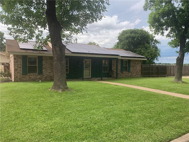 1707 Shawnee St, Navasota, TX 77868 - view of front of house featuring solar panels, brick siding, and covered porch