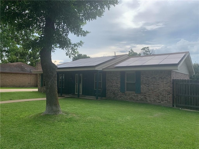 1707 Shawnee St, Navasota, TX 77868 - ranch-style house with covered porch, solar panels, and brick siding
