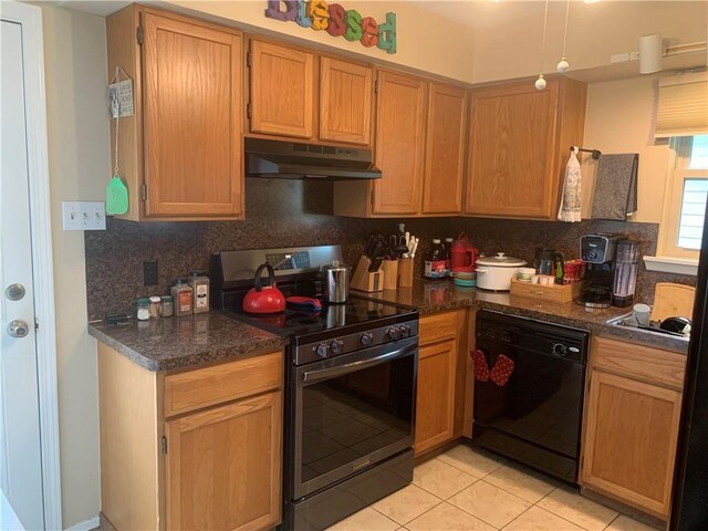 1707 Shawnee St, Navasota, TX 77868 - kitchen featuring stainless steel range with electric cooktop, under cabinet range hood, dishwasher, light tile patterned floors, and decorative backsplash