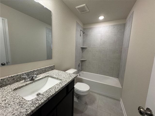 full bathroom with tile patterned flooring, tiled shower / bath combo, toilet, and vanity