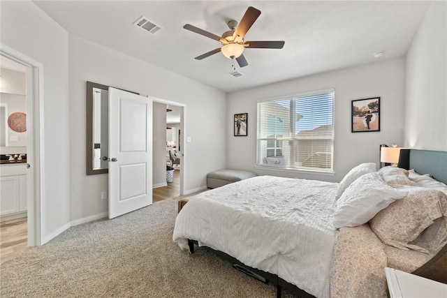 1988 Chief St, Bryan, TX 77807 - bedroom with baseboards, ceiling fan, light colored carpet, and ensuite bathroom