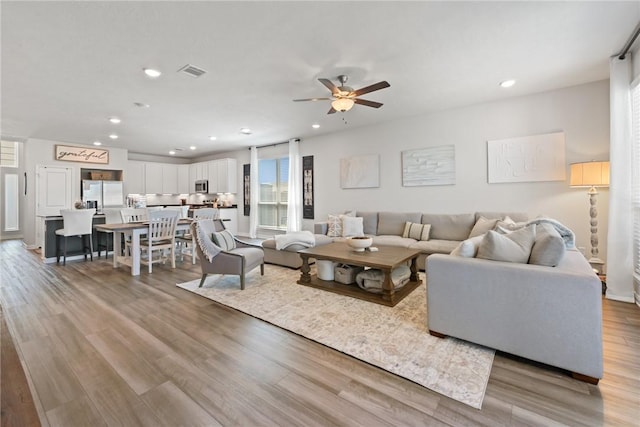 1988 Chief St, Bryan, TX 77807 - living area featuring a ceiling fan, light wood-style floors, and recessed lighting