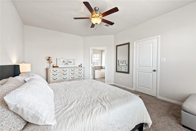 1988 Chief St, Bryan, TX 77807 - bedroom with carpet flooring, baseboards, connected bathroom, and a ceiling fan