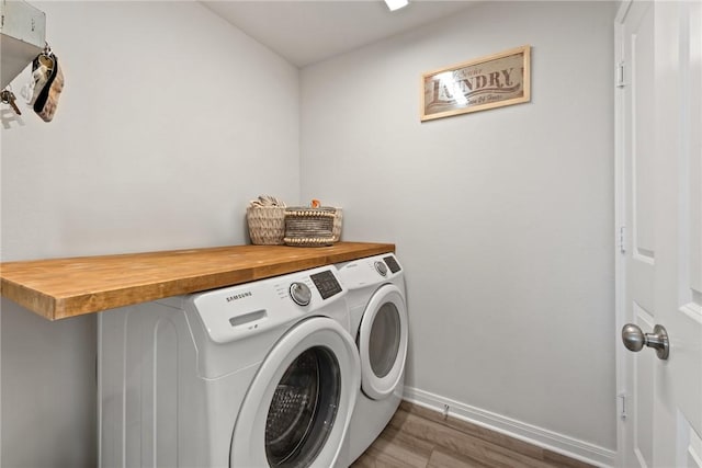 1988 Chief St, Bryan, TX 77807 - laundry room with independent washer and dryer, wood finished floors, and baseboards