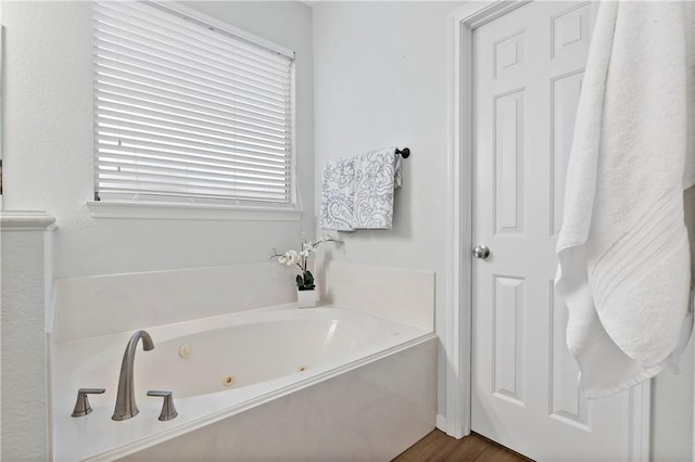 bathroom featuring a bath and wood-type flooring