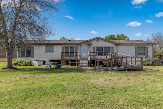 rear view of property with a lawn and a deck