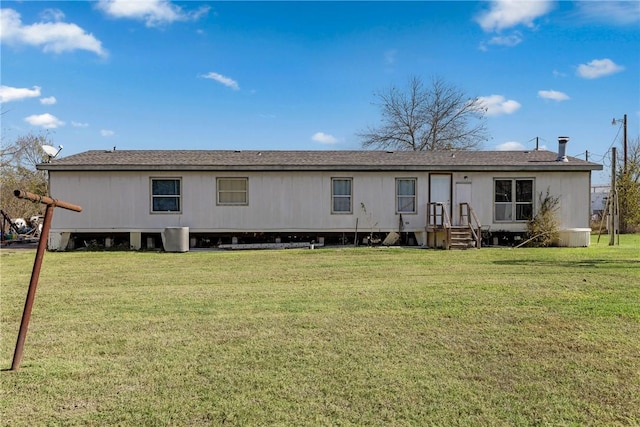 back of property with a lawn and cooling unit