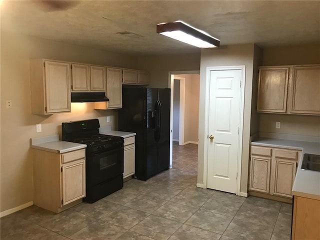 2001 Broken Arrow Cir, Bryan, TX 77807 - kitchen featuring black appliances, under cabinet range hood, light countertops, baseboards, and light brown cabinetry