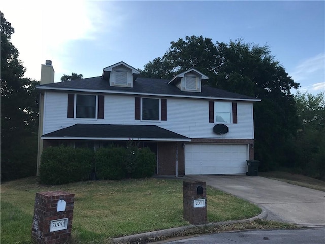 2001 Broken Arrow Cir, Bryan, TX 77807 - view of front of home featuring a front yard, a chimney, a garage, and concrete driveway