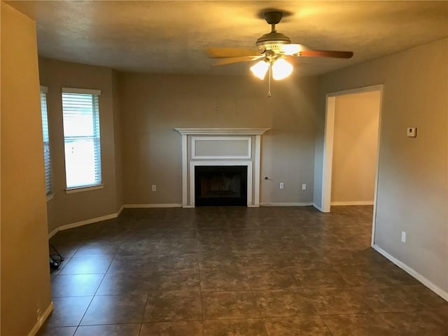 2001 Broken Arrow Cir, Bryan, TX 77807 - unfurnished living room featuring ceiling fan, a fireplace, and baseboards