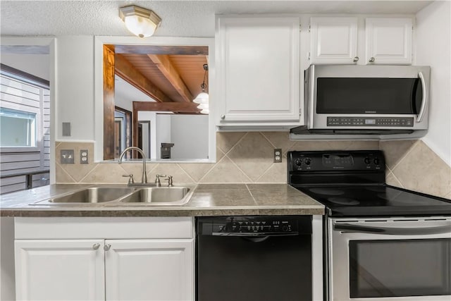 1536 Wolf Run, College Station, TX 77840 - kitchen with stainless steel appliances, a sink, backsplash, white cabinetry, and dark countertops