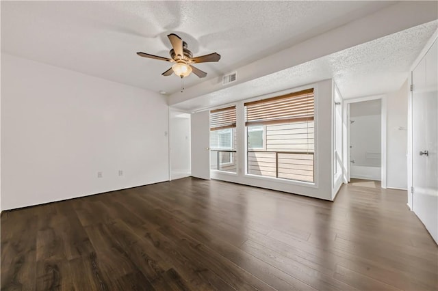 1536 Wolf Run, College Station, TX 77840 - empty room with wood finished floors, ceiling fan, and a textured ceiling