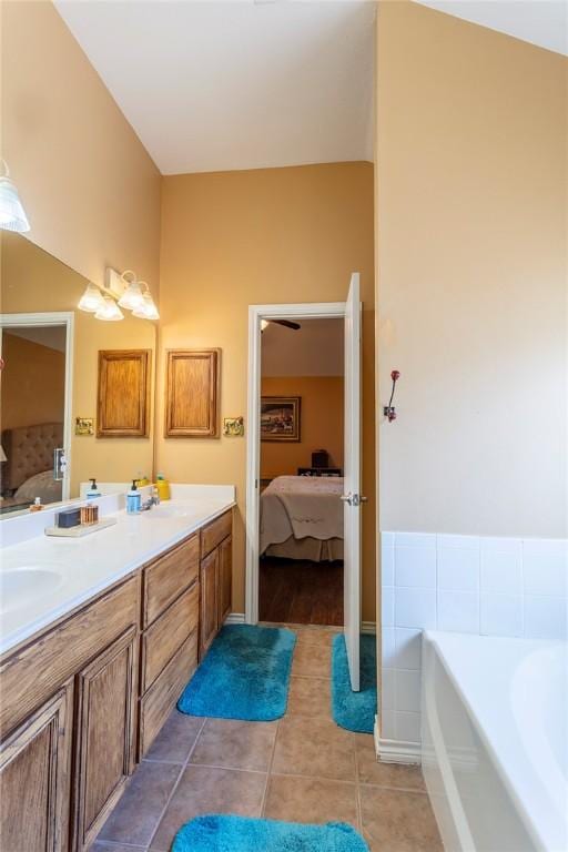 1701 Bradley Rd, College Station, TX 77845 - bathroom featuring connected bathroom, double vanity, tile patterned flooring, and a bath