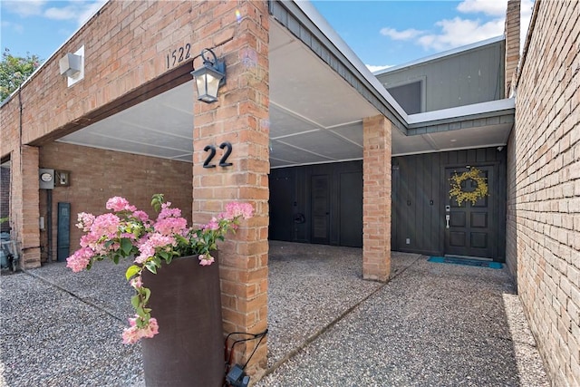 doorway to property featuring brick siding